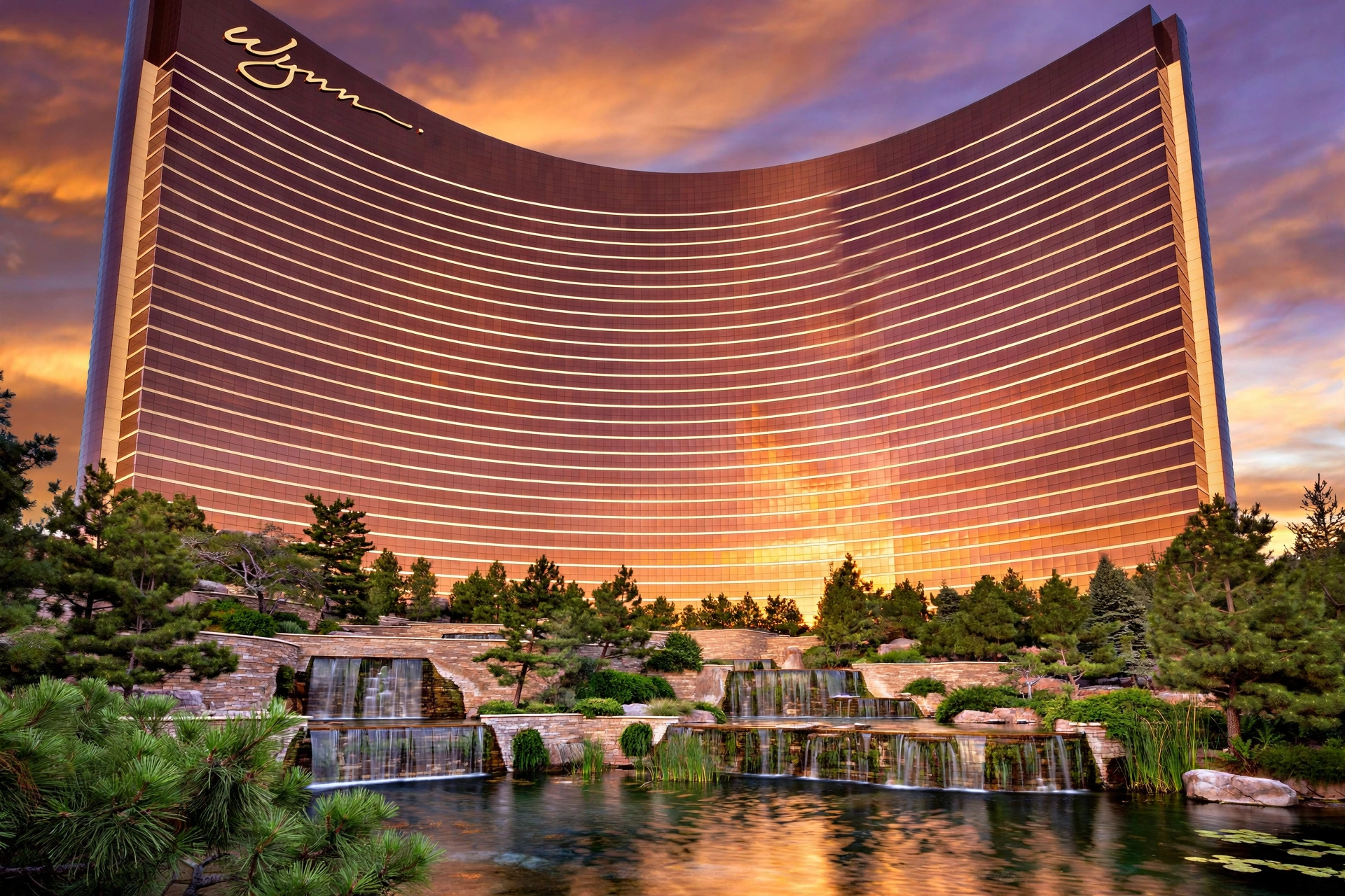 Wynn Las Vegas curved bronze hotel tower surrounded by lush subtropical gardens
